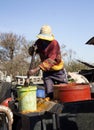 `Bloemfontein / South Old black farmer loading food for pigs to plastic buckets