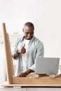 Blog about furniture assembly. Positive african american man showing thumb up to laptop computer, copy space, crop Royalty Free Stock Photo