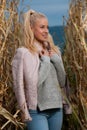 Blog style fashion photo of cute blond woman on corn field in late autumn
