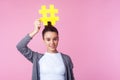 Blogger advertising. Portrait of trendy brunette teen girl smiling and holding big hashtag symbol above head. pink background Royalty Free Stock Photo