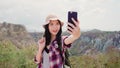 Blogger Asian backpacker woman record vlog video on top of mountain, young female happy using mobile phone make vlog video enjoy Royalty Free Stock Photo