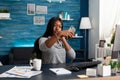 Blogger black student smiling while taking selfie with smartphone sitting at desk table Royalty Free Stock Photo