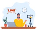 Blogger communicates in live stream with followers. Man records video content on camera. Influencer creating video for a blog. Royalty Free Stock Photo