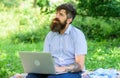 Blogger create content for social network. Blogger becoming inspired by nature. Man bearded with laptop nature