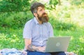 Blogger create content for social network. Blogger becoming inspired by nature. Man bearded with laptop nature