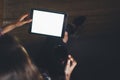 Blogger girl person holding computer with blank screen on background bokeh, hipster girl using tablet technology in home, female h Royalty Free Stock Photo