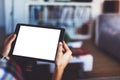 Blogger girl person holding computer with blank screen on background bokeh, hipster girl using tablet technology in home, female h Royalty Free Stock Photo