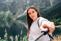 Blogger girl. Young female travel photographer with smartphone on summer mountain rock nature background. Freedom Royalty Free Stock Photo