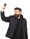 Blogger or hipster with beard takes selfie photo