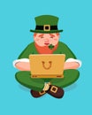 Blogger leprechaun Saint Patrick answers incoming letters and luck wishes in a laptop and sits on blue background isolated. Vector Royalty Free Stock Photo