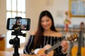 Blogger live broadcasting music instrument tutorial on social media. vlogger recording online vlog video