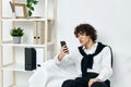 blogger in the room on the couch with the phone online learning living room Royalty Free Stock Photo