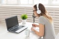 Blogger, streamer and broadcasting concept - young woman DJ working on the radio.