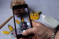 a blogger takes photos of the process of making Easter bunnies on his phone