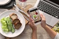 Blogger taking photo of food with mobile phone Royalty Free Stock Photo