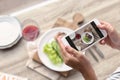 Blogger taking photo of food with mobile phone Royalty Free Stock Photo