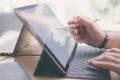 Blogger using mobile touchpad for work.Closeup view of male hands using stylus pen for touching electronic tablet screen Royalty Free Stock Photo