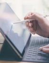 Blogger using mobile touchpad for work.Closeup view of male hands using stylus pen for touching electronic tablet screen Royalty Free Stock Photo