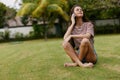 blogger woman palm tree phone nature smiling t-shirt park grass happy lifestyle Royalty Free Stock Photo