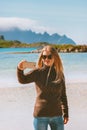 Blogger woman taking selfie photo by smartphone camera influencer girl traveling in Norway