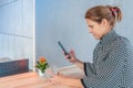 City lifestyle woman using cell phone in cafe. Copy space Royalty Free Stock Photo