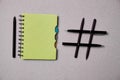 Blogging, blog and blogger or social media concept: notepad and hashtag symbol on grey background