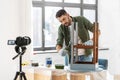 man or blogger repainting old table at home