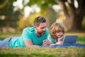 Blogging. Happy father using laptop relax with schooler son holding laptop. Childhood and parenthood kids concept. Video