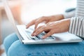 When blogging is a passion...an unrecognizable young woman using her laptop at home.