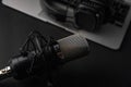 Blogging, podcasts, streams and broadcast, background. Black studio microphone on a laptop on a black background Royalty Free Stock Photo