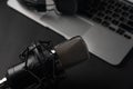 Blogging, podcasts, streams and broadcast, background. Black studio microphone on a laptop on a black background Royalty Free Stock Photo