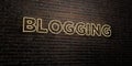 BLOGGING -Realistic Neon Sign on Brick Wall background - 3D rendered royalty free stock image