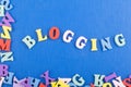 BLOGGING word on blue background composed from colorful abc alphabet block wooden letters, copy space for ad text