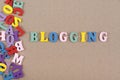 BLOGGING word on wooden background composed from colorful abc alphabet block wooden letters, copy space for ad text