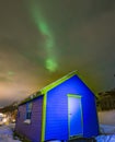 Northen light over blue cabin at Blokken. Lofoten Islands Norway.