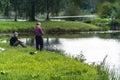 Blome / Latvia - August 20th, 2018: Photo of Two Millennials Fishing - Spending Quality Leisure Time