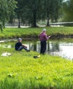 Blome / Latvia - August 20th, 2018: Photo of Two Millennials Fishing - Spending Quality Leisure Time