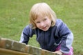 Blond adorable little girl playing playground Royalty Free Stock Photo