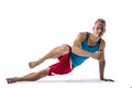 Blond athletic young man exercizing on the floor