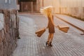 Blond attractive girl in a hat after shopping in the rays of the summer sun Royalty Free Stock Photo