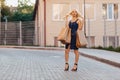 Blond attractive girl in a hat after shopping in the rays of the summer sun Royalty Free Stock Photo