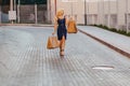 Blond attractive girl in a hat after shopping in the rays of the summer sun Royalty Free Stock Photo