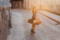 Blond attractive girl in a hat after shopping in the rays of the summer sun Royalty Free Stock Photo