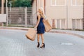 Blond attractive girl in a hat after shopping in the rays of the summer sun Royalty Free Stock Photo