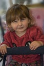 Baby girl with blond hair sitting on swing Royalty Free Stock Photo