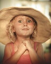 Blond baby girl with summer hat on the beach