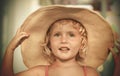 Blond baby girl with summer hat on the beach Royalty Free Stock Photo