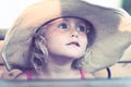 Blond baby girl with summer hat on the beach Royalty Free Stock Photo