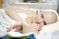 blond bald woman lying on the bed