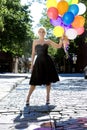 Blond with balloons out in the sun